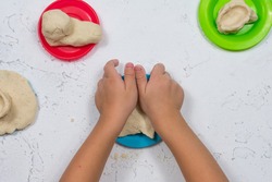 Children's hands sculpt salty dough. Development of fine motor skills of the hands. Development of children's creativity