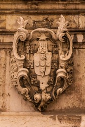 Stone ancient heraldic coat of arms on the wall