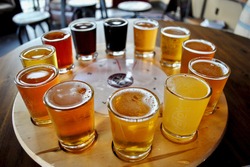 A flight of beer samplers. Beers range from light pale ales through dark stouts. Pilsner, lager, bock, Kölsch, bitter, Irish Red Ale, American Brown Ale, Amber, Brown Ale, Porter, India Pale Ale (IPA)