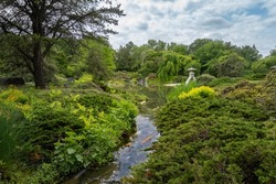 Japanese Garden at the Montreal Botanical Garden. Strolling garden with stone lantern, stream, pond and native Canadian plants arranged with  Japanese aesthetics and philosophical ideas.  