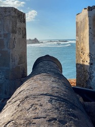 Cannon at Castillo San Felipe del Morro or el Morro in San Juan, Puerto Rico. Fortress by the sea. View of Fortín San Juan de la Cruz or El Cañuelo, protecting the bay with crossfire.