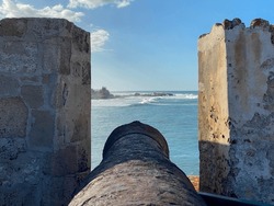 Cannon at Castillo San Felipe del Morro or el Morro in San Juan, Puerto Rico. Fortress by the sea. View of Fortín San Juan de la Cruz or El Cañuelo, protecting the bay with crossfire.
