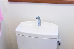 Clean white tank of flush toilet