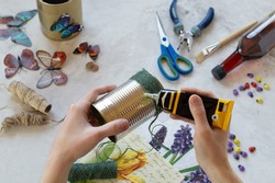 Decorating tin cans with decoupage napkins, jute rope and using various decor elements. Do it yourself. Step by step. Step 2. Applying glue to the jar. There is no waste. Other uses of packaging..