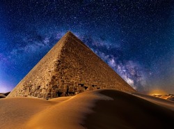 Pyramid of Khafre in desert dunes at night against the stars and Milky Way Galaxy. Giza, Egypt. Astrophotography, fantastic background