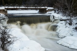 Buttermilk Falls in Forest Mills Ontario Canada.  A large cascade waterfall that thunders through the river in winter.  