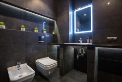bathroom interior in a modern style, dark color, real apartment