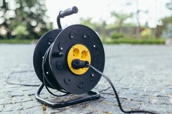 Extension wire with socket wrapped in a black drum
