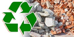 Recovery and recycling of concrete and brick rubble debris on construction site after a demolition of a brick building.