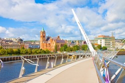 Urban skyline of Derry city (also called Londonderry) in northern Ireland with the famous Peace Bridge (Europe - Northern Ireland).