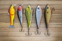 Fishing lures on a wooden background
