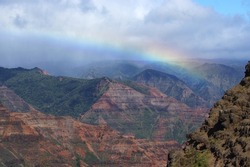 Rainbow spans the vast Waimea Canyon in Hawaii
