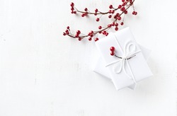 White Christmas Presents with Christmas Decorations on painted wood; flat lay arrangement. Christmas background. White background. Copy space. Top view.
