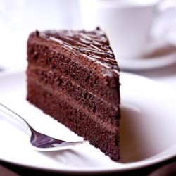A slice of delicious chocolate cake. Piece of Cake on a Plate. Sweet food. Sweet dessert. Close up.  