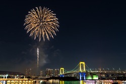 Nightview of Rainbow Bridge and fireworks in Tokyo, Japan.