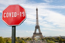 COVID-19 sign with Eiffel tower in Paris, France. Warning about pandemic in France. Coronavirus disease. COVID-2019 alert sign