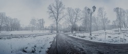 Panoramic view of foggy covered in snow city park in winter on the center of Riga, Latvia