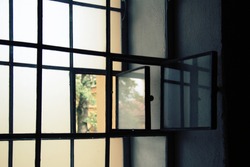 Window in the prison cell. Lattices on the window in the room. Deprivation of liberty.