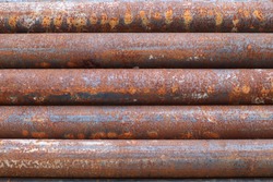 Rusty steel pipe keep in stock yard  Bangkok in construction site , rust texture background. abstract background concept. rusty pipe syndrome concept