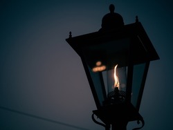 A gas lamp at dusk in autumn.