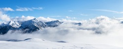 Panoramic view of snowy mountains. Mountain ski resort, snow slope. Winter vacation.