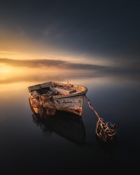 Old wrecked fishing boat sunrise calm sunset