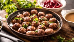 Swedish meatballs, kottbullar, in a pan topped with fresh parsley.