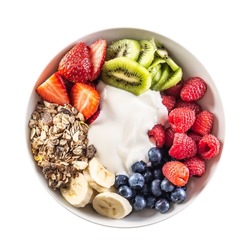 Top view of isolated fruit and yoghurt bowl with cereals, kiwi, strawberries, banana, blueberries and raspberries.