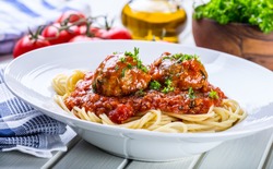 Meat balls with spaghetti and tomato sauce.
