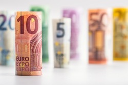 Several hundred rolls of euro banknotes in different positions.