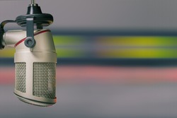 For radio stations and podcasts: background with professional microphone and audio console