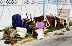 A pile of household furnishings, damaged by Hurricane Irma, placed curbside, awaiting trash removal.
