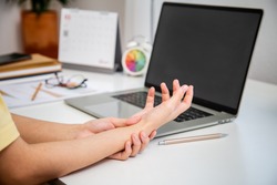Concept office syndrome hand pain from occupational disease, woman having wrist pain from using computer, wrist pain.