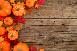 Autumn multicolored  leaves and pumpkins old brown wood table background with copy space, flat lay, minimal concept