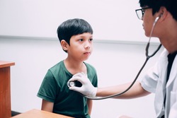 Male doctor hold stethoscope examining child boy patient