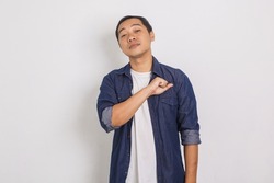Portrait of confident and proud asian man with chin lifting gesture and punching chest isolated on white background
