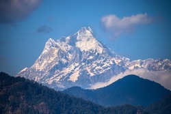 Kanchanjangha and Khangchendzonga is the third-highest mountain in the world. The snow-clad peak of the mountain towers above the thick green forest.