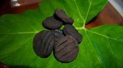 Anishi, a Naga delicacy of fermented leaves made into patties and smoked over the fire or sun dried. It is used as an ingredient in traditional Ao Naga food.

