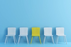 outstanding yellow chair among light blue chair. Chairs with one odd one out in light blue color room.