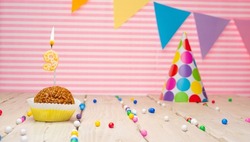 Happy birthday for 9 years old. Festive background with muffin. Copy the birthday card for a nine year old on a pink background
