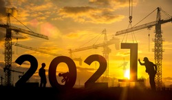Silhouette construction site,Cranes building construction 2021 year sign