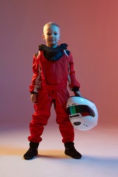 Cool boy child racer with helmet, standing in neon light. Kart racing school poster. Competition announcement