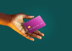 African american female hand holds levitating template mockup Bank credit card with online service on green background