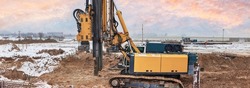 A powerful drilling rig for peeling at a construction site. Operation of the drilling rig in northern conditions. Pile foundations. Bored piles. Pagoramic view. Banner format