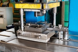 Automation hydraulic press stamping machine production line. industrial metalworking machines. Close-up of a hydraulic press in an industrial workshop at a factory