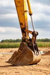 Close up of excavator bucket at construction site. Construction equipment for earthworks