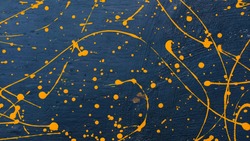 abstract oil color yellow color splatter paint on dark blue texture background. color paint texture background design