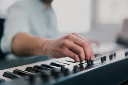 young man's hands playing keyboard piano, composing music , music record concep, art, song composition, dj