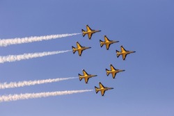 Airplanes form a triangular formation during an air show.
