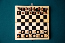 A chess board with the game pieces on the board with king, Queen and Pawn